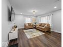 Bright living room with hardwood floors, leather sofas, and modern decor at 208 S Conger St, , IN 47272