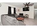 Cozy living room with plank floors, a modern ceiling fan, and comfortable seating at 243 S 3Rd Ave, Beech Grove, IN 46107