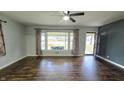 Bright living room with hardwood floors, large window, and view of the front yard at 2455 Endsley Dr, Indianapolis, IN 46227
