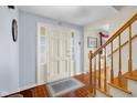 Bright foyer with tile flooring, staircase, and front door with sidelights at 2665 Chestnut St, Columbus, IN 47201