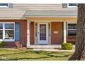 Inviting front porch with a hanging swing, white columns, and a brick facade at 2665 Chestnut St, Columbus, IN 47201