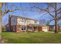 Charming two-story home with brick accents, well-manicured lawn, and inviting front porch at 2665 Chestnut St, Columbus, IN 47201