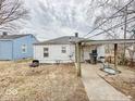 View of back exterior with covered patio, grill, trash can, and other exterior features at 2959 N Lasalle St, Indianapolis, IN 46218