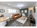 Staged living room features modern furnishings and vinyl plank flooring with modern lighting at 3053 Adams St, Indianapolis, IN 46218