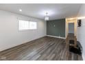Bright living room featuring vinyl plank flooring, a modern light fixture and lots of natural light at 3053 Adams St, Indianapolis, IN 46218
