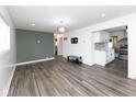 Spacious living room open to kitchen, featuring vinyl plank flooring and a modern light fixture at 3053 Adams St, Indianapolis, IN 46218