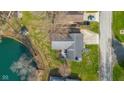 Aerial view of home showing backyard, mature trees, and proximity to a lake at 3232 Beech Dr, Columbus, IN 47203