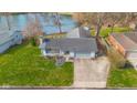 Aerial view showcasing the well-maintained exterior, landscaping, and location near the water at 3232 Beech Dr, Columbus, IN 47203