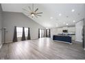 Open-concept living area with cathedral ceilings, wood-look floors, recessed lights, and a ceiling fan at 3328 Stoddard Pl, Indianapolis, IN 46217