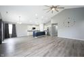Bright and airy living room with wood-look floors, cathedral ceilings, recessed lighting and a view of the kitchen at 3328 Stoddard Pl, Indianapolis, IN 46217