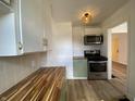 Well-lit kitchen with stainless steel appliances and green cabinetry at 3516 N Sherman Dr, Indianapolis, IN 46218