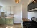 Modern kitchen featuring sleek appliances, butcher block countertops and stylish green cabinetry at 3516 N Sherman Dr, Indianapolis, IN 46218