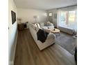 Bright living room featuring a large sectional, modern flooring, and plenty of natural light at 3703 Church Dr, Anderson, IN 46013