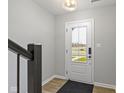 Neat entryway with a glass paneled white front door, and modern light fixture at 4261 Barrel Ln, Westfield, IN 46062