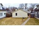 Backyard featuring a quaint yard, a well-maintained walkway, and mature trees for a serene outdoor space at 4619 Carrollton Ave, Indianapolis, IN 46205