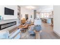 Open-concept living room flows to the kitchen, featuring a fireplace and built-in shelving at 5537 Broadway St, Indianapolis, IN 46220