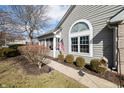 Side view of a charming single-story home with attractive landscaping and an American flag at 5721 Quail Crossing Dr, Indianapolis, IN 46237