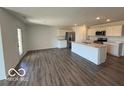 Spacious open-concept kitchen and living area with stainless steel appliances and a large center island at 6635 Sulgrove Pl, Indianapolis, IN 46221