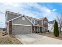 A well-maintained house showcasing a blend of vinyl siding and brick, complemented by an attached two-car garage and spacious driveway at 6677 W Longview Dr, McCordsville, IN 46055