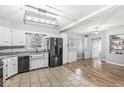 Bright eat-in kitchen boasts stainless steel appliances, white cabinets, and updated countertops at 714 School St, Greenfield, IN 46140