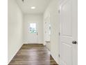 Bright entryway featuring hardwood floors, neutral walls, and a sun tunnel skylight at 7168 Jackson Dr, Cumberland, IN 46229