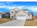 Beautiful home featuring a well-manicured lawn, concrete driveway, and a two-car garage at 7168 Jackson Dr, Cumberland, IN 46229