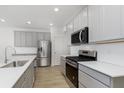Modern kitchen featuring stainless steel appliances, gray cabinets, and a subway tile backsplash at 7324 Shroyer Way, Noblesville, IN 46062