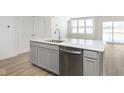 Stylish kitchen island with a stainless steel dishwasher and a white countertop at 7324 Shroyer Way, Noblesville, IN 46062