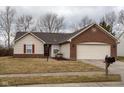 Charming single-story home featuring brick and vinyl siding with an attached two-car garage at 7332 Jackie Ct, Indianapolis, IN 46221
