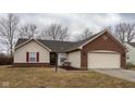 Charming single-story home featuring brick and vinyl siding with an attached two-car garage at 7332 Jackie Ct, Indianapolis, IN 46221
