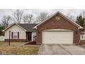 Charming single-story home featuring brick and vinyl siding with an attached two-car garage at 7332 Jackie Ct, Indianapolis, IN 46221