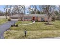 Beautiful ranch-style home boasting a lovely front yard and inviting curb appeal at 7481 Holliday E Dr, Indianapolis, IN 46260