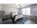 Bright bedroom with a ceiling fan, a large window, and stylish furnishings at 7674 Bayhill Dr, Indianapolis, IN 46236
