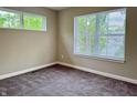 Cozy bedroom featuring plush carpeting and large windows that provide natural light at 859 N Oakland Ave, Indianapolis, IN 46201
