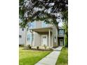 Neutral colored two-story home with a welcoming front porch and sidewalk at 859 N Oakland Ave, Indianapolis, IN 46201