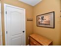 Neutral hallway with wall art and wood accent furniture at 9640 Clover Leaf Ln, Fishers, IN 46038