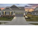 Charming home with a two-car garage and well-maintained lawn at 11758 Harvester S Cir, Noblesville, IN 46060