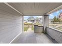 Covered porch with painted brick columns and decorative railing, offering a cozy outdoor space and street views at 1210 S State Ave, Indianapolis, IN 46203