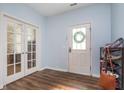 Bright entryway with stylish wood floors, glass panel doors, and a convenient shoe rack at 12777 Rotterdam Rd, Fishers, IN 46037
