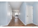 Bright hallway featuring hardwood floors and views of the dining area with natural light at 12777 Rotterdam Rd, Fishers, IN 46037