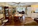 Inviting dining area featuring hardwood floors, a ceiling fan, and an open flow at 1408 Lawrence Way, Anderson, IN 46013