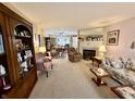 Spacious living room with fireplace and plush furnishings, with view into dining area at 1408 Lawrence Way, Anderson, IN 46013