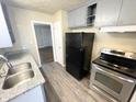Kitchen featuring stainless steel appliances, granite counters, and gray cabinets at 1422 E 49Th St, Indianapolis, IN 46205