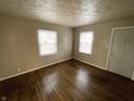 Bright living room with hardwood floors and natural light from two windows at 1422 E 49Th St, Indianapolis, IN 46205