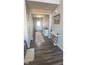Inviting entryway with hardwood floors, white wainscoting, console tables, and a colorful patterned rug at 15408 Brown Jack Dr, Fishers, IN 46040