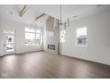 Spacious living room with vaulted ceilings, wooden beams, fireplace, and ample natural light at 1668 Carrollton Rail Dr, Westfield, IN 46074