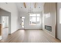 Open-concept living room featuring a fireplace, hardwood floors, and natural light at 1668 Carrollton Rail Dr, Westfield, IN 46074