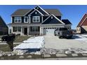 Inviting two-story house with a two-car garage and attractive curb appeal, enhanced by a truck parked on the driveway at 1704 Beach St, Greenwood, IN 46143
