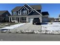 Beautiful two-story house with three-car garage, showing well-manicured front lawn, and a modern truck parked on the driveway at 1704 Beach St, Greenwood, IN 46143