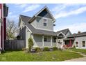 Inviting two-story house with a white-railed porch, neat landscaping, and pleasant curb appeal at 1724 Prospect St, Indianapolis, IN 46203